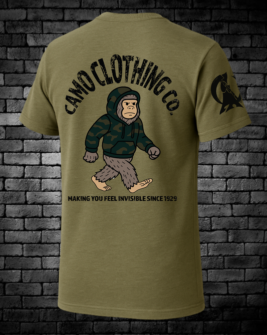 Camo Clothing Co Logo with Bigfoot wearing a camo hoodie in the center and "Making you feel invisible since 1929" under Bigfoot