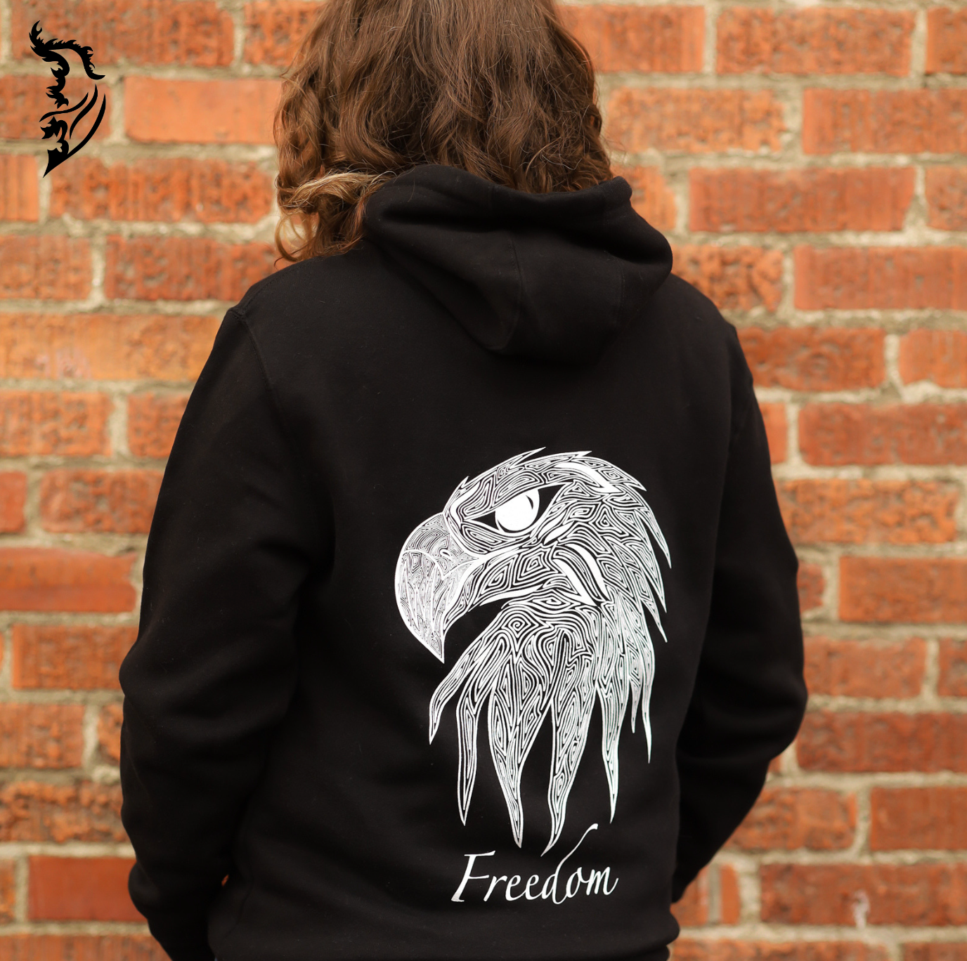 Black hoodie featuring a bold eagle head with artistic linework and 'Freedom' lettering, plus a front left chest brand logo