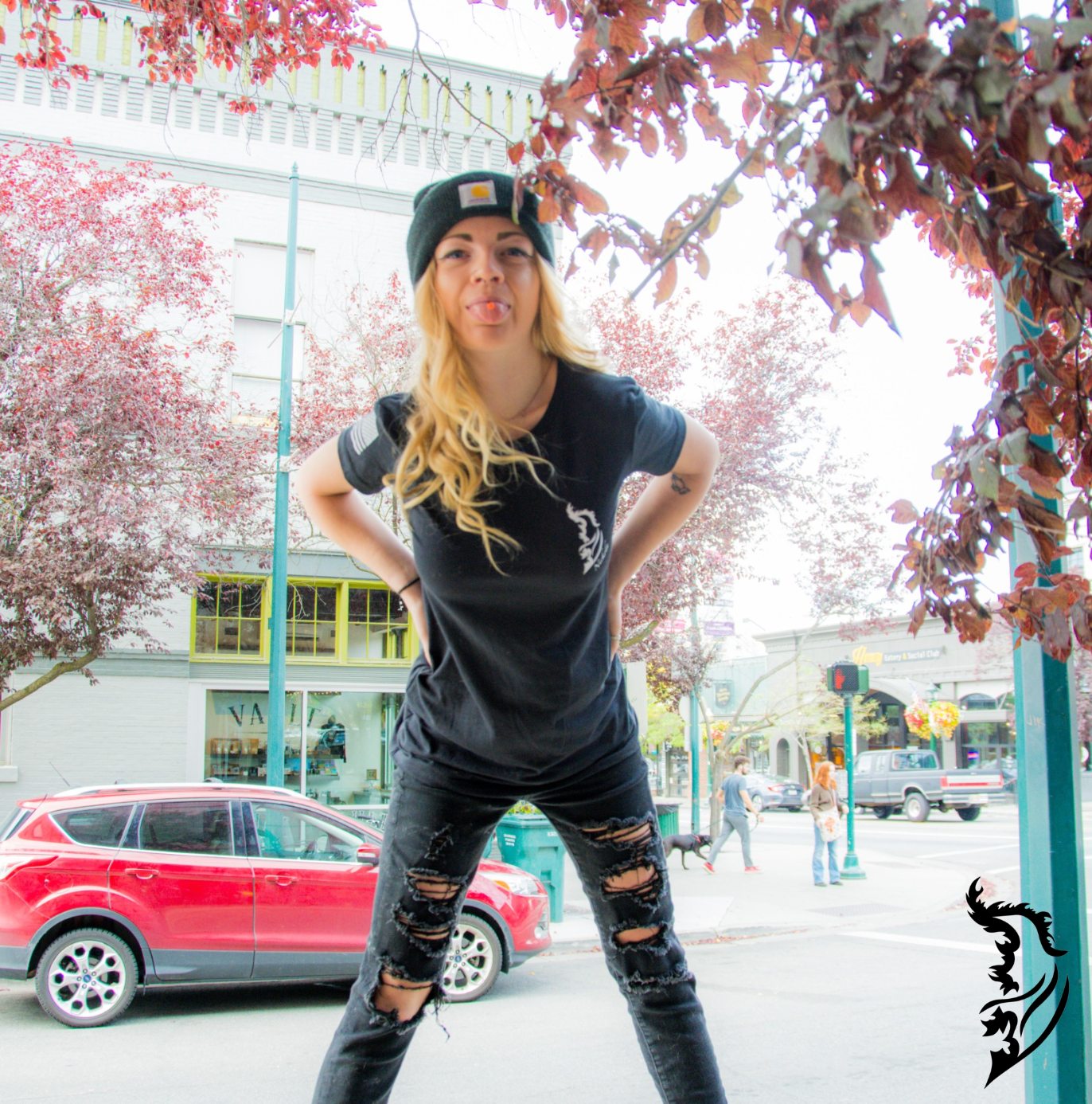 Black ladies tee front view with a subtle brand logo on the left chest, paired with a bold eagle and 'Freedom' design on the back