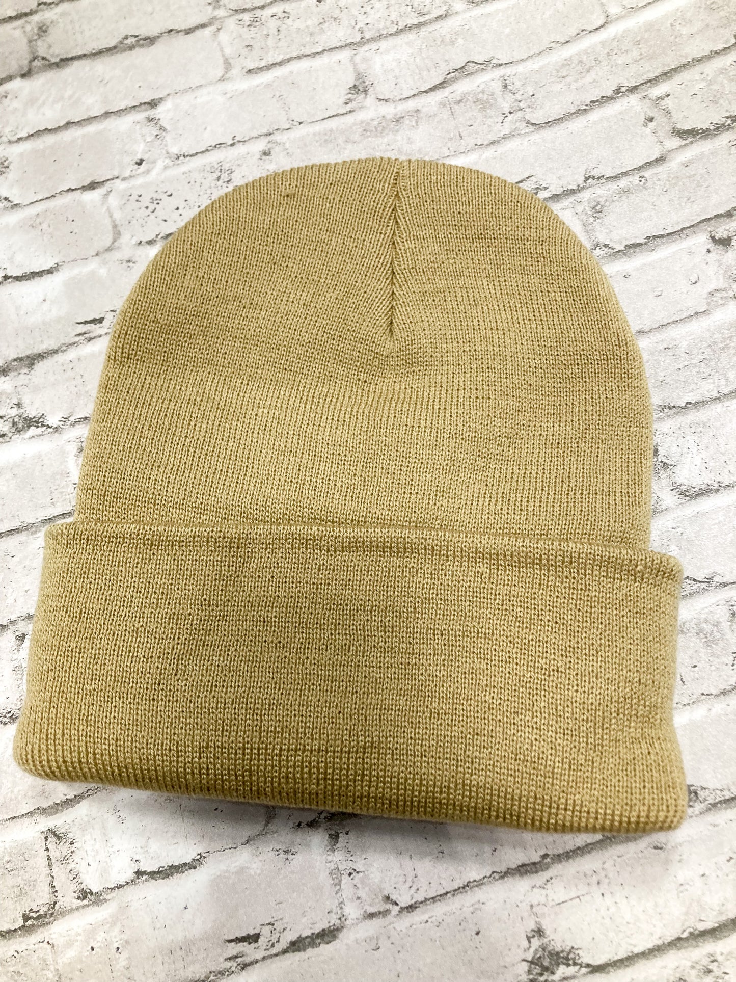 Back of product image of a streetwear beanie camel colored, made from soft knit fabric.