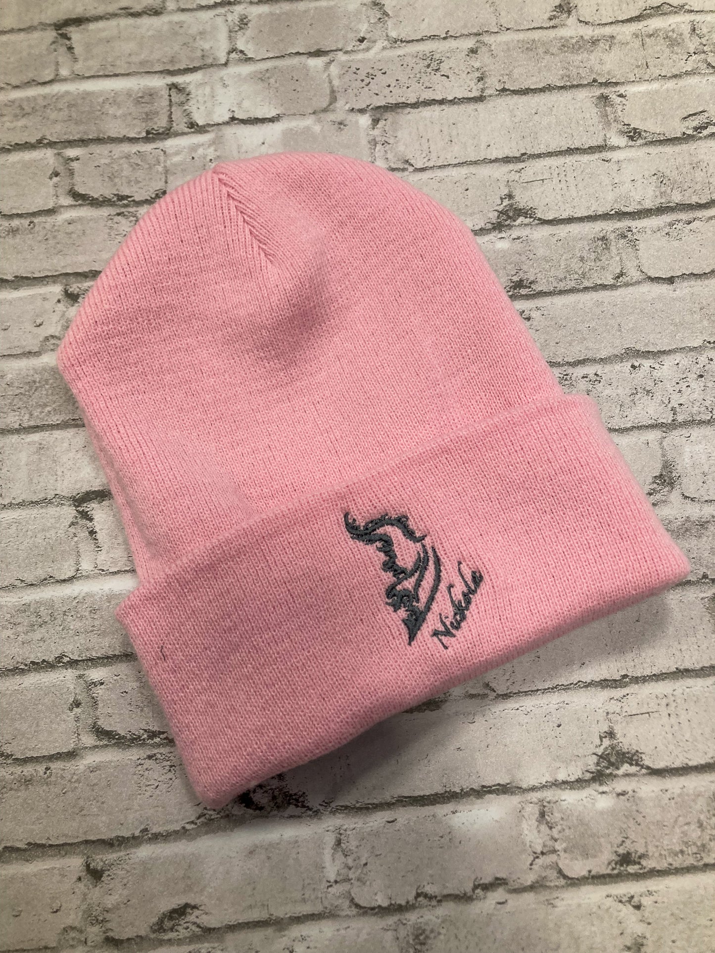 Product image of a streetwear beanie in pink, made from soft knit fabric.