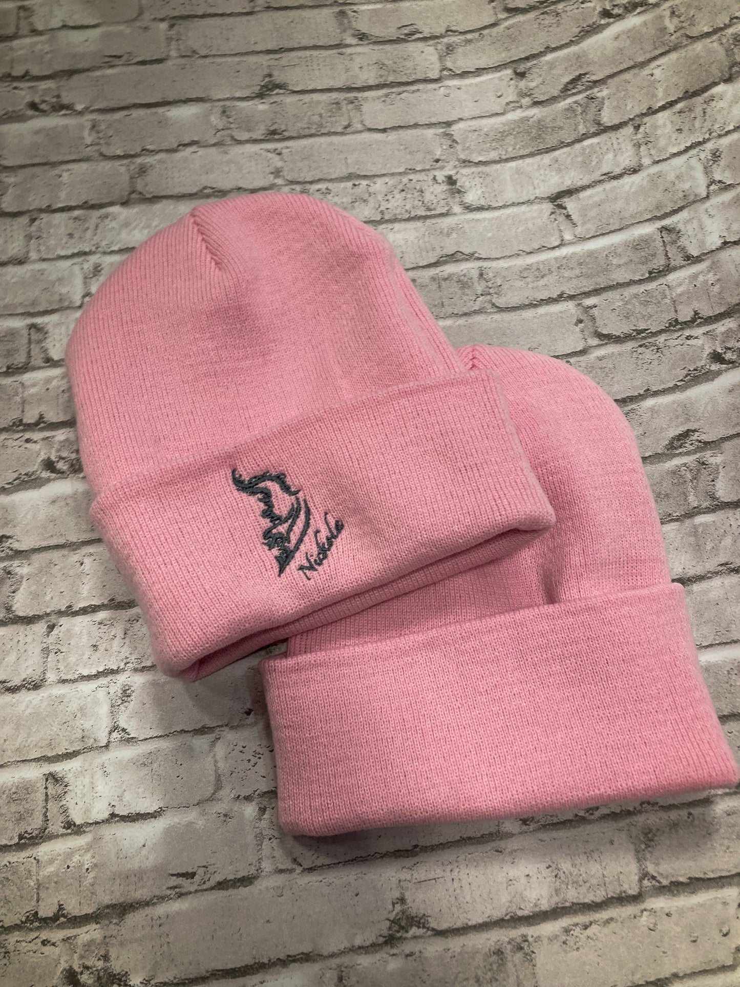 Front and back product image of a streetwear beanie in pink, made from soft knit fabric.