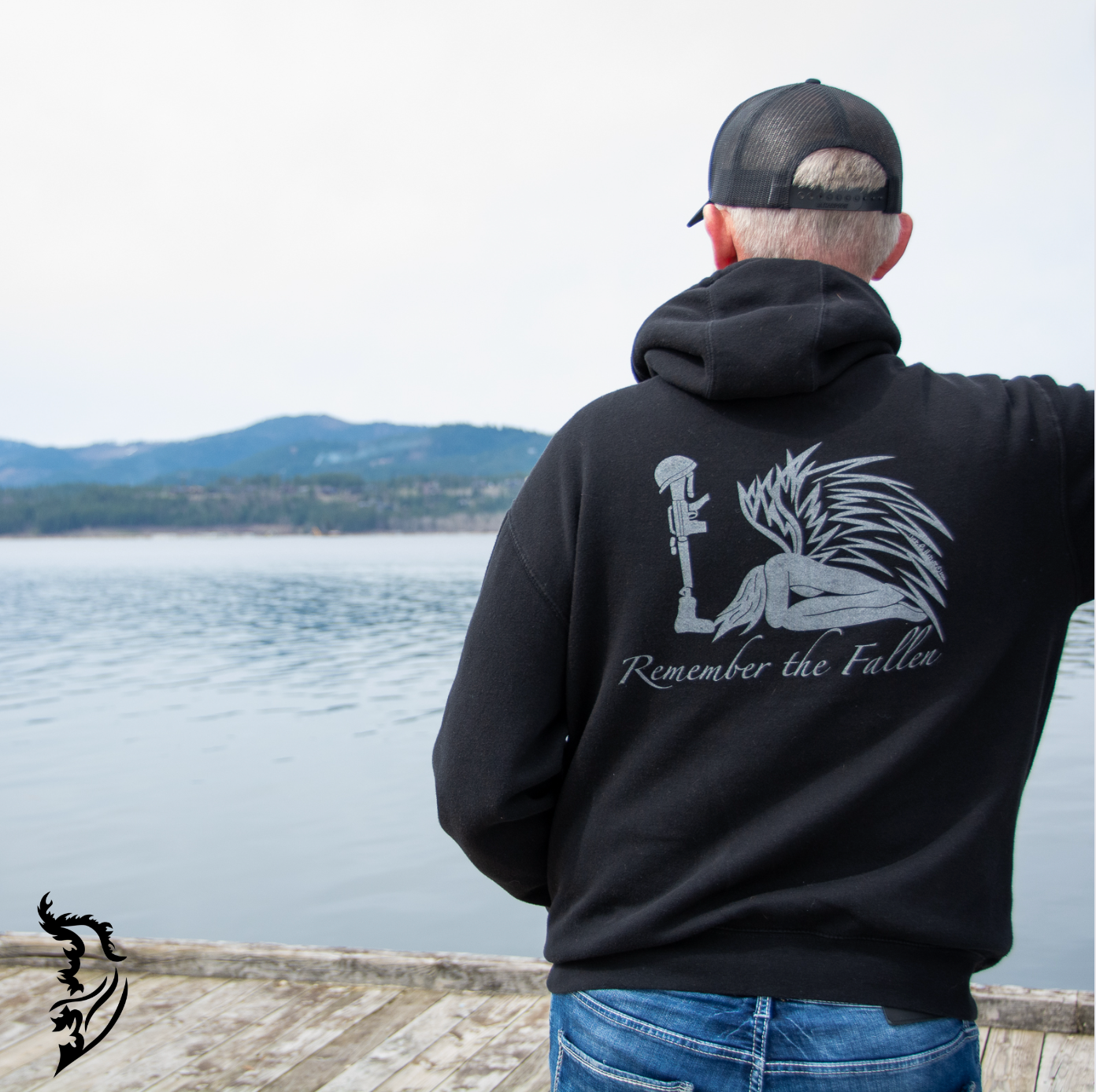 Hand-drawn back design of a kneeling angel before a battlefield cross, symbolizing remembrance and sacrifice on a black hoodie.