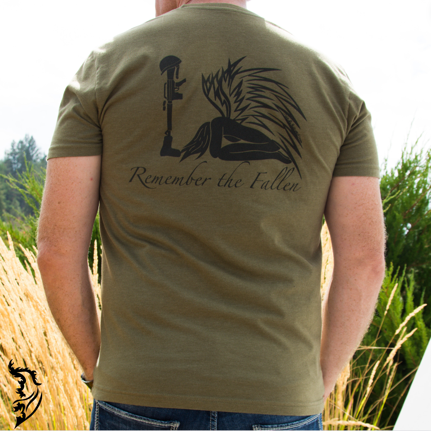 Back view of a men's tee featuring a hand-drawn angel kneeling with wings extended, before a soldier’s boot, rifle, helmet, and dog tags in tribute to fallen soldiers.