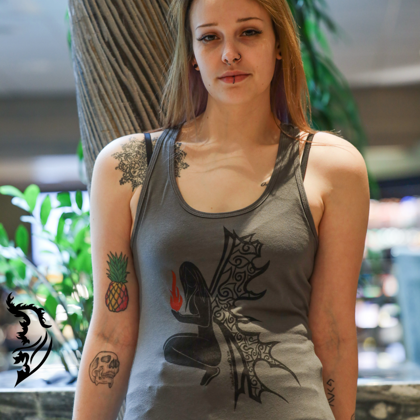 Model wearing a grey fire angel sleeveless tank top with an edgy hand-drawn design
