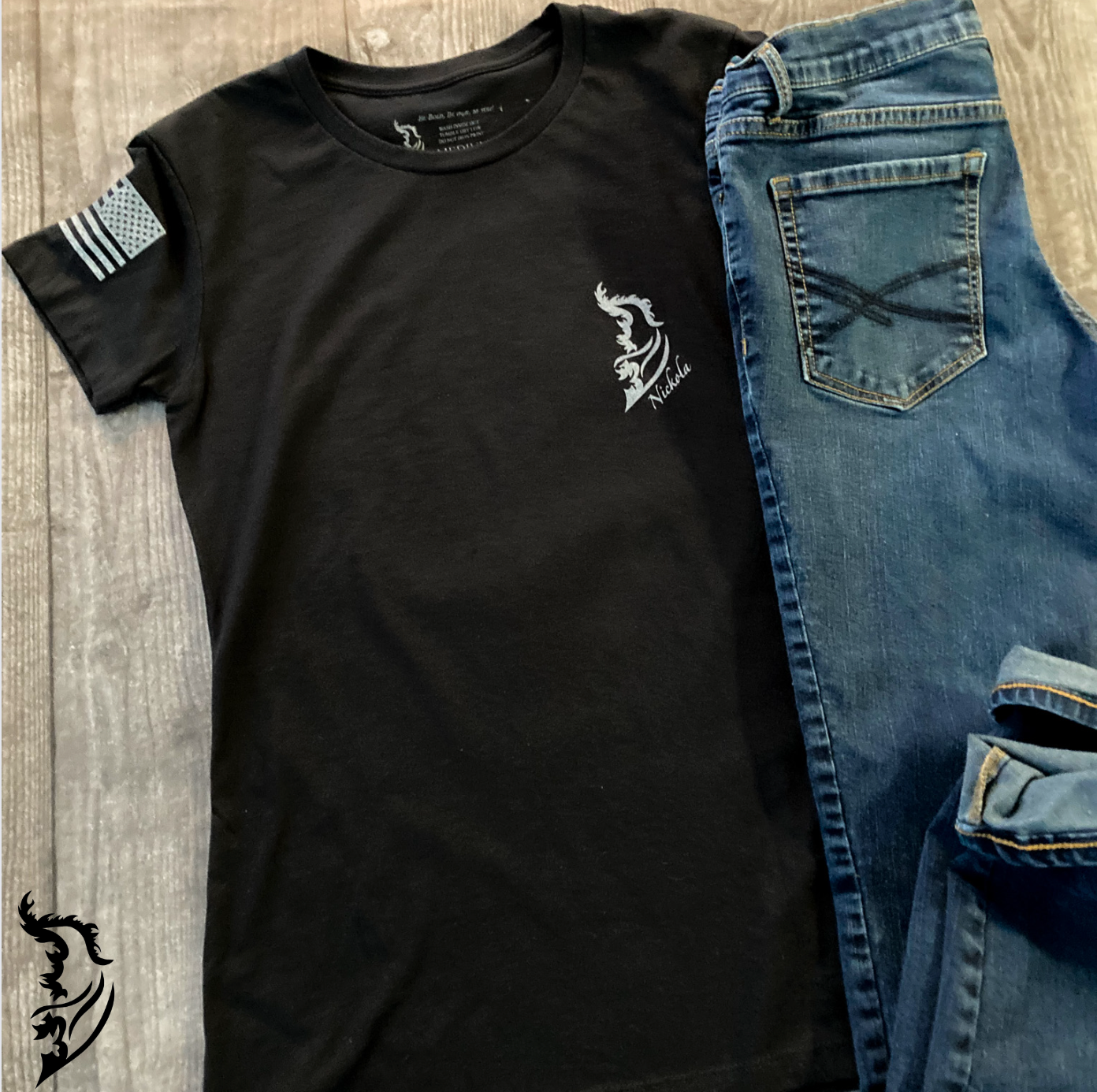 Front view of a ladies tee with a minimalist brand logo on the left chest, complementing the bold Spartan helmet and 'Liberty or Death' design on the back.