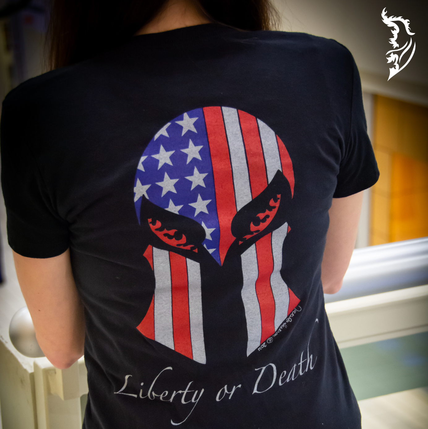 Detailed back print of a Spartan helmet with the American flag design and 'Liberty or Death' text, symbolizing strength and freedom.