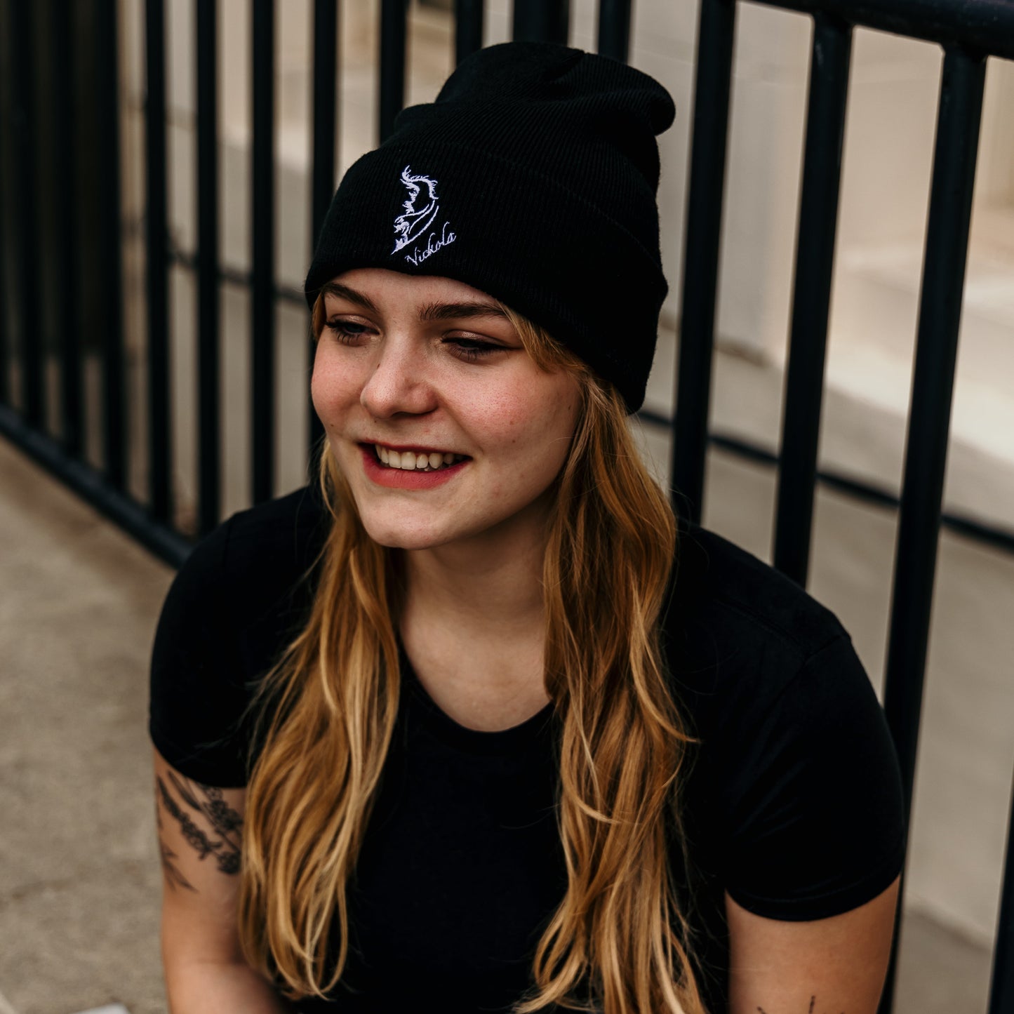 Model wearing a streetwear beanie in classic black, made from soft knit fabric.