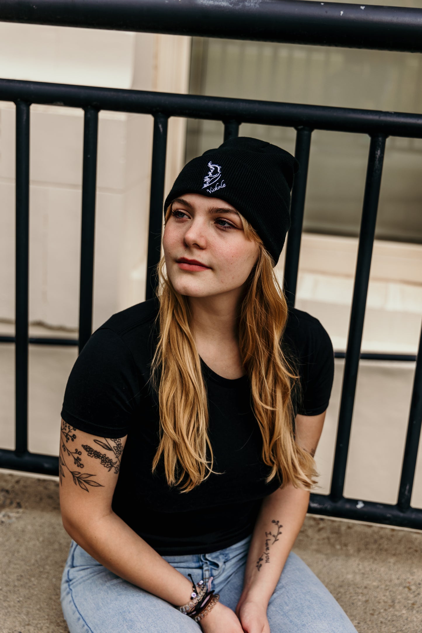 Model wearing a streetwear beanie in classic black, made from soft knit fabric.