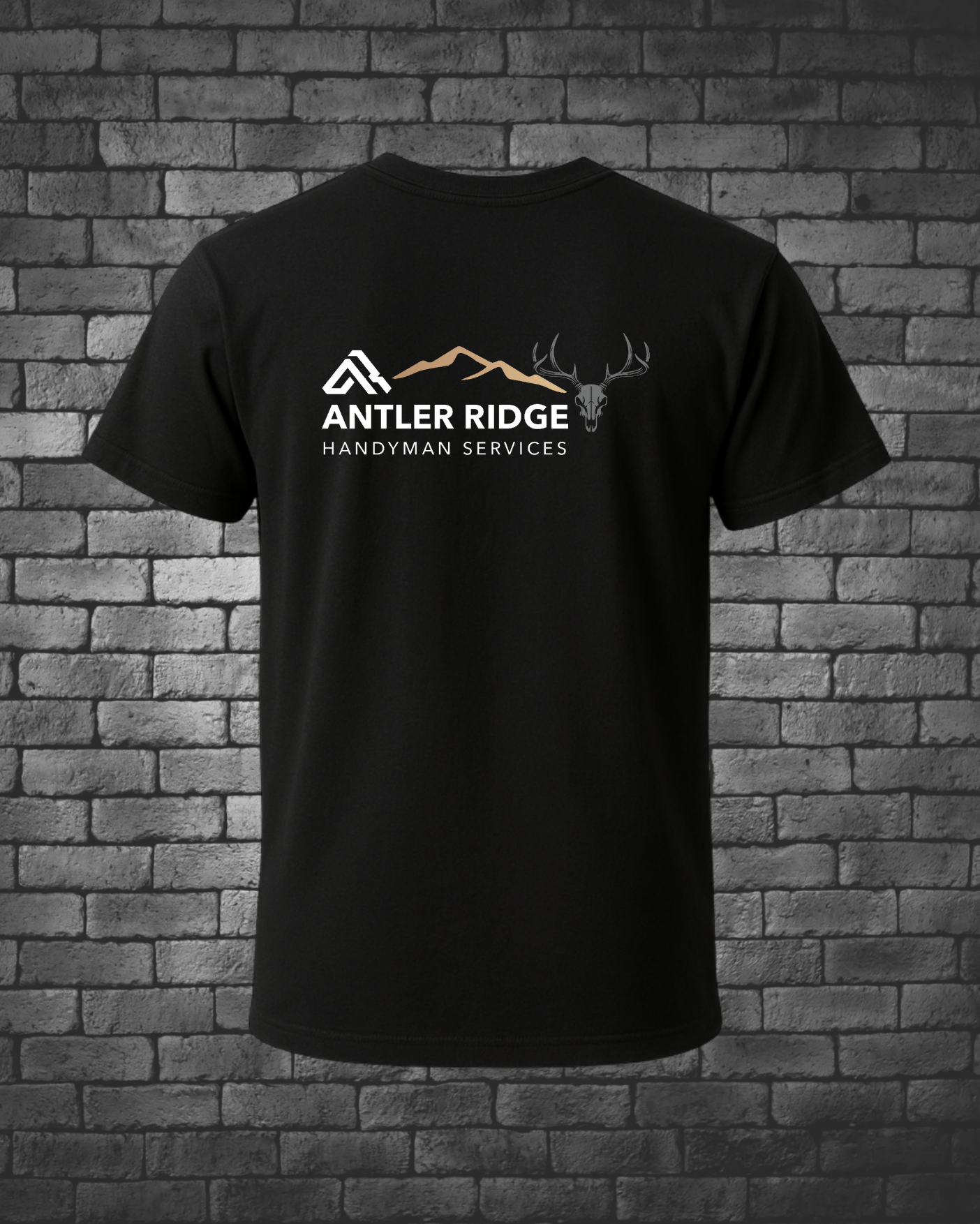 Black t-shirt with Antler Ridge Handyman Services logo on a brick wall background