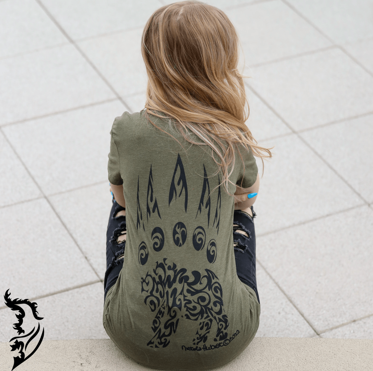 Hand-drawn bear paw with tribal bear in bottom of paw
