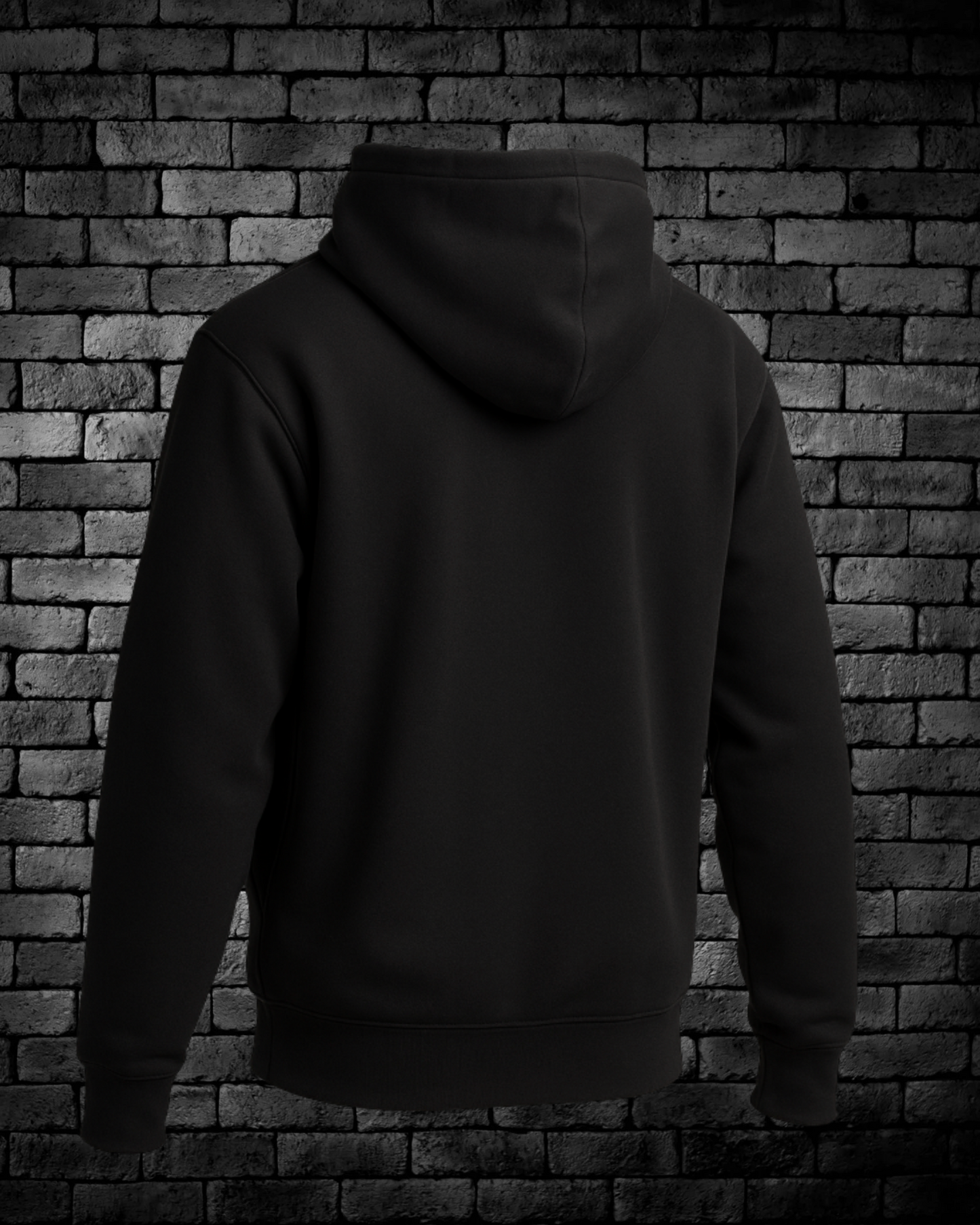 Black hoodie against a brick wall