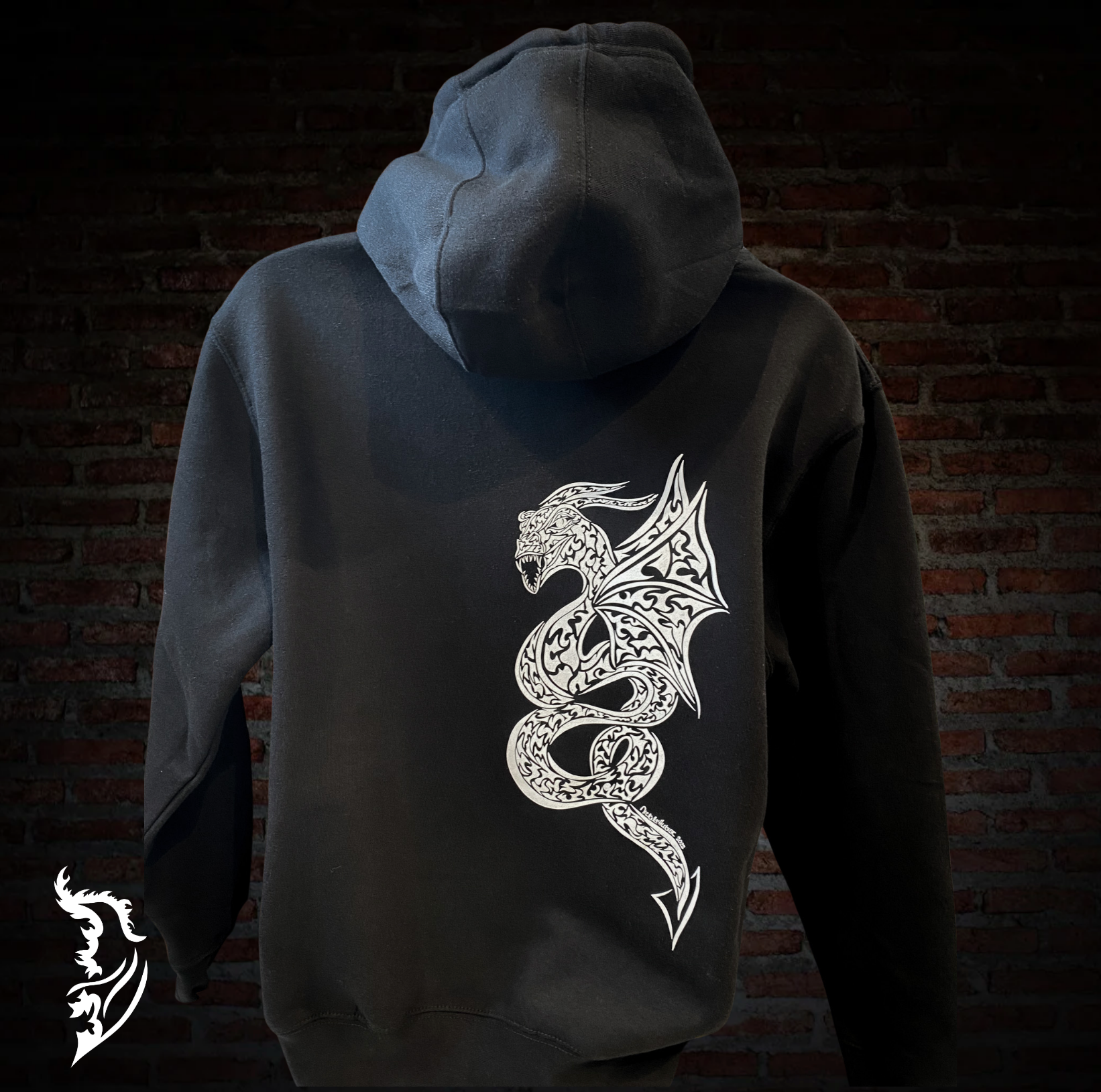 Hand-drawn black fleece-lined hoodie featuring a majestic coiled dragon design down the back, symbolizing balance, harmony, and spiritual protection. The front features a white angel wing logo on the left chest.