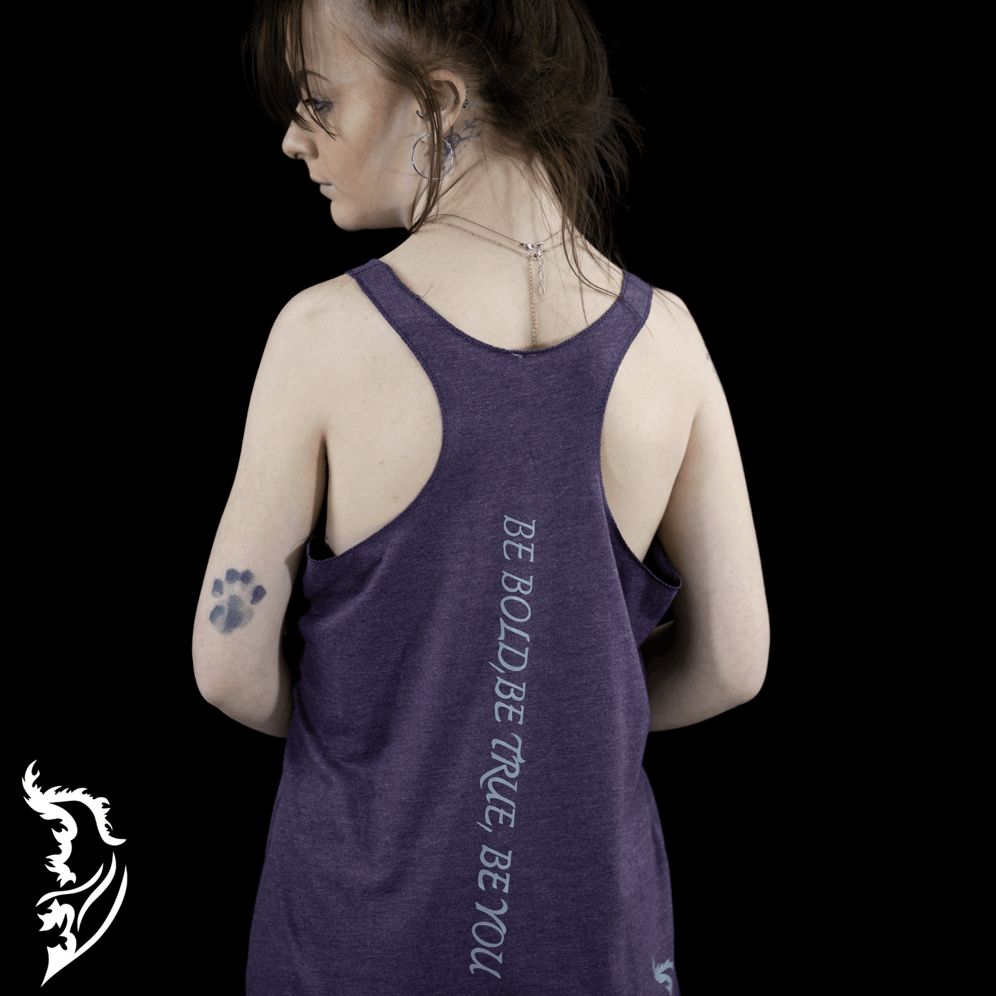 Daisy Racer Back TankBack view of a woman wearing a purple Street Style by Nickola tank top featuring the vertical slogan “Be Bold, Be True, Be You” 