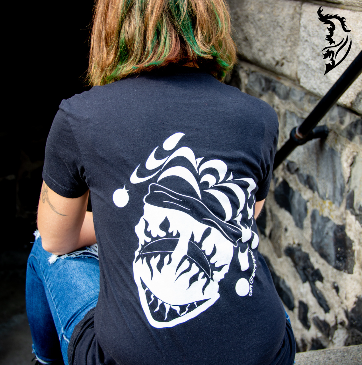 Female model wearing joker tee on set of stairs
