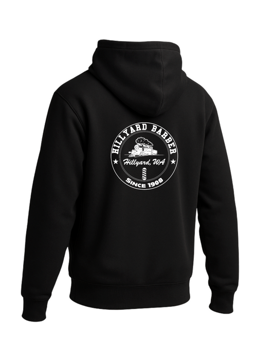 A black hoodie shown from the back.A circular white graphic  reading 'HILLYARD BARBER' around the top and 'SINCE 1908' around the bottom, with a vintage train illustration and a barbershop pole in the center. The text 'Hillyard, WA' appears across the middle.
