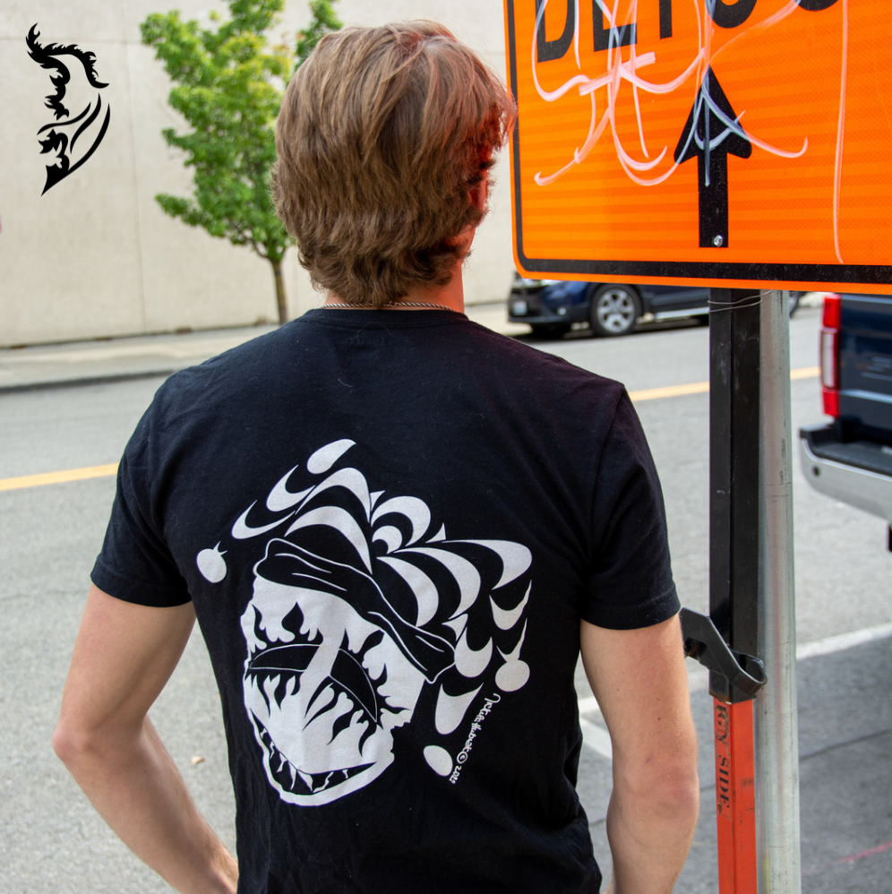 Male Model wearing Joker Tee standing next to road construction sign