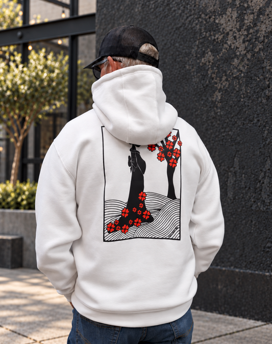A 6'1" male model wearing an XL white hoodie, blue jeans, and a black cap. The back of the hoodie has black and red hand-drawn blossom artwork.