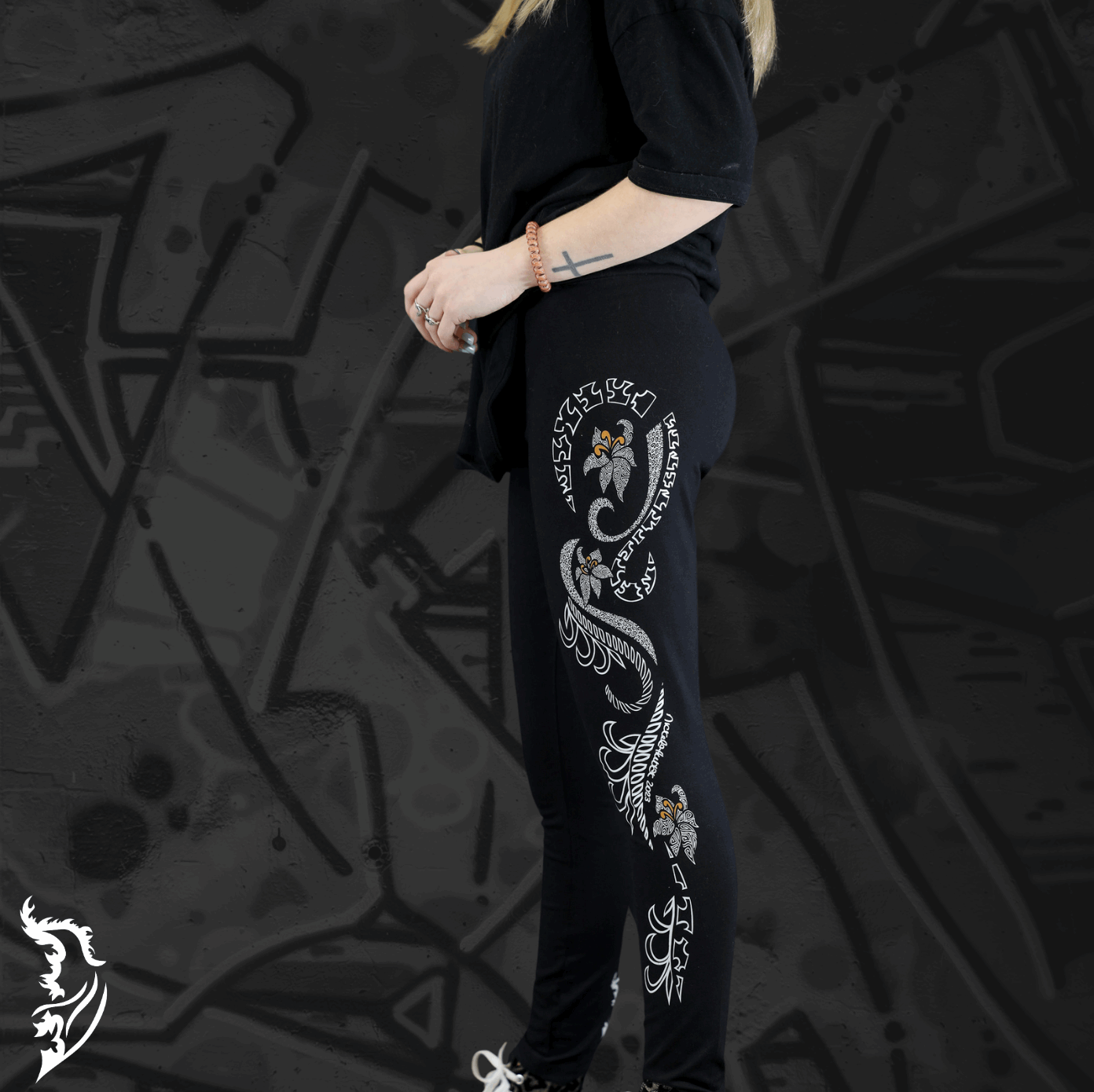 Model Wearing Lily Leggings showing Hand-drawn Lily design left side of leg