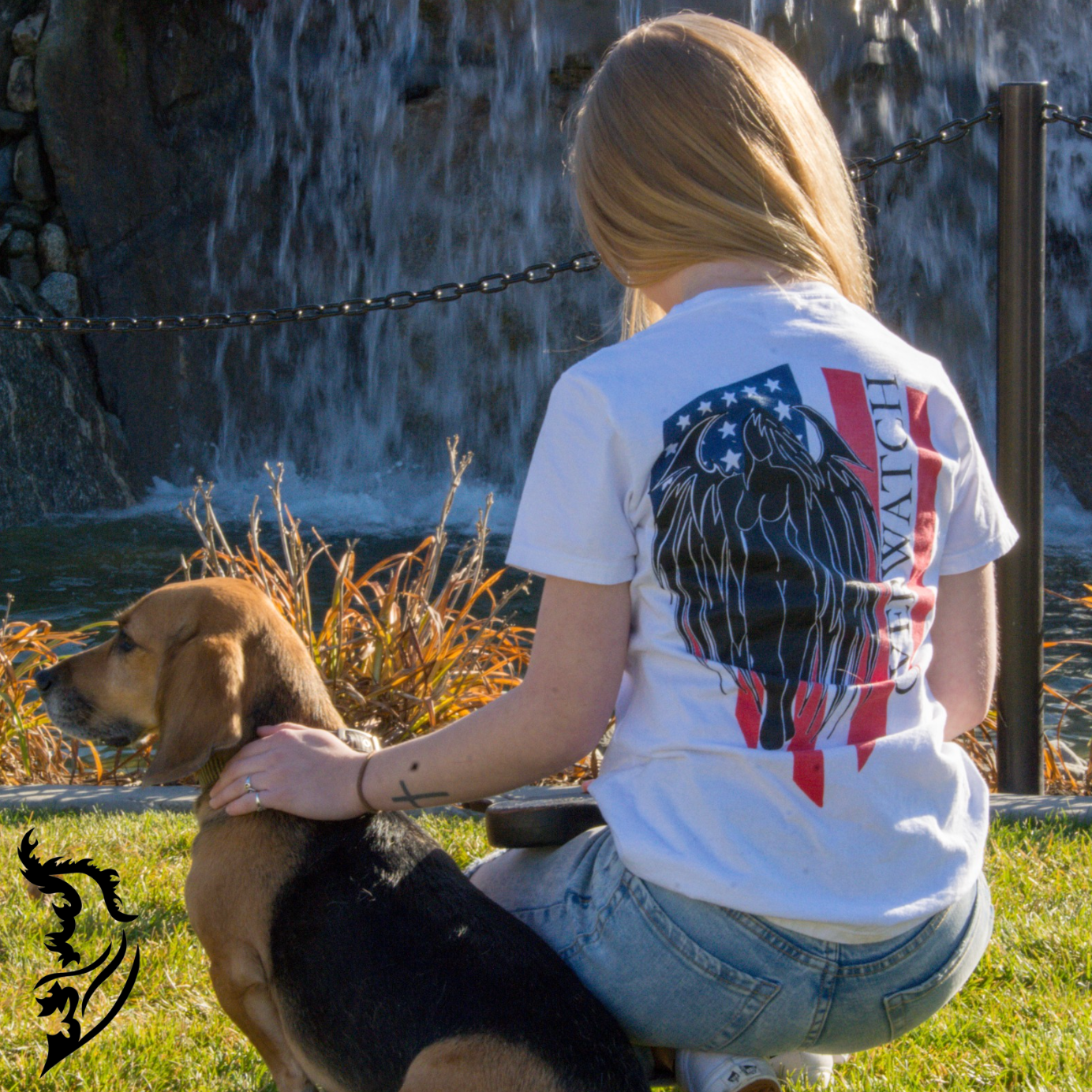 Model wearing Overwatch T-Shirt in park with dog sitting next to her.  Showcasing Hand-drawn American Flag with Angel and Overwatch written down Flag