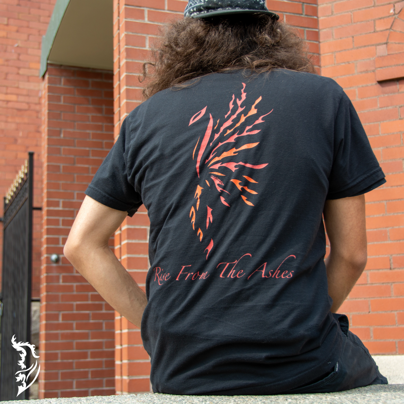 Hand-drawn Phoenix in Red, Orange and Yellow with Rise from the Ashes written below