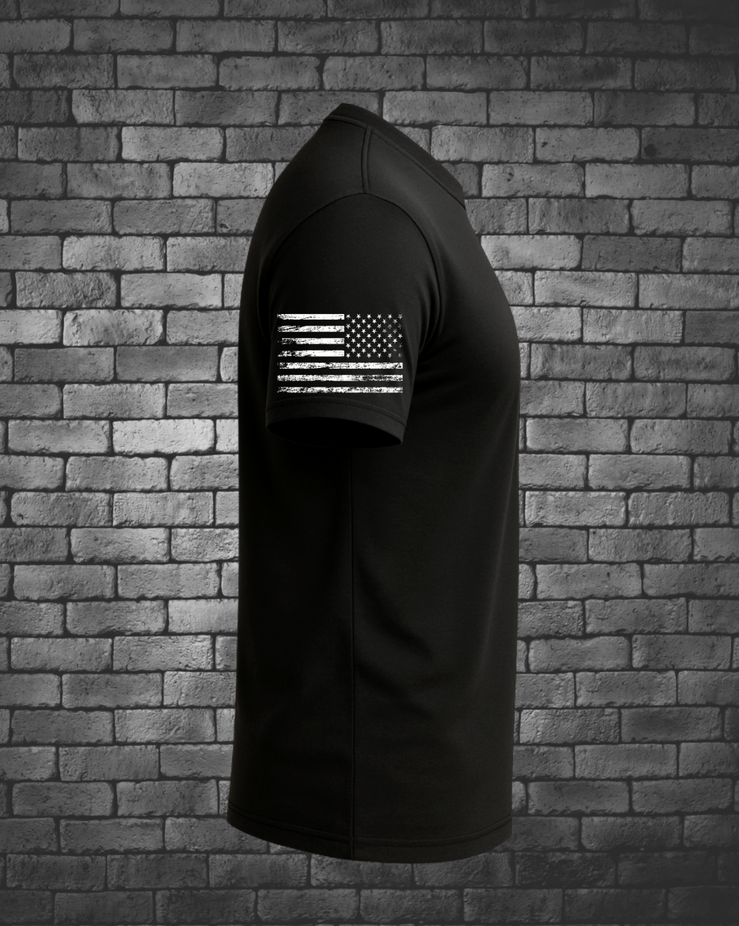 Side view of black JTAC tribute T-shirt featuring a distressed white American flag printed on the sleeve.
