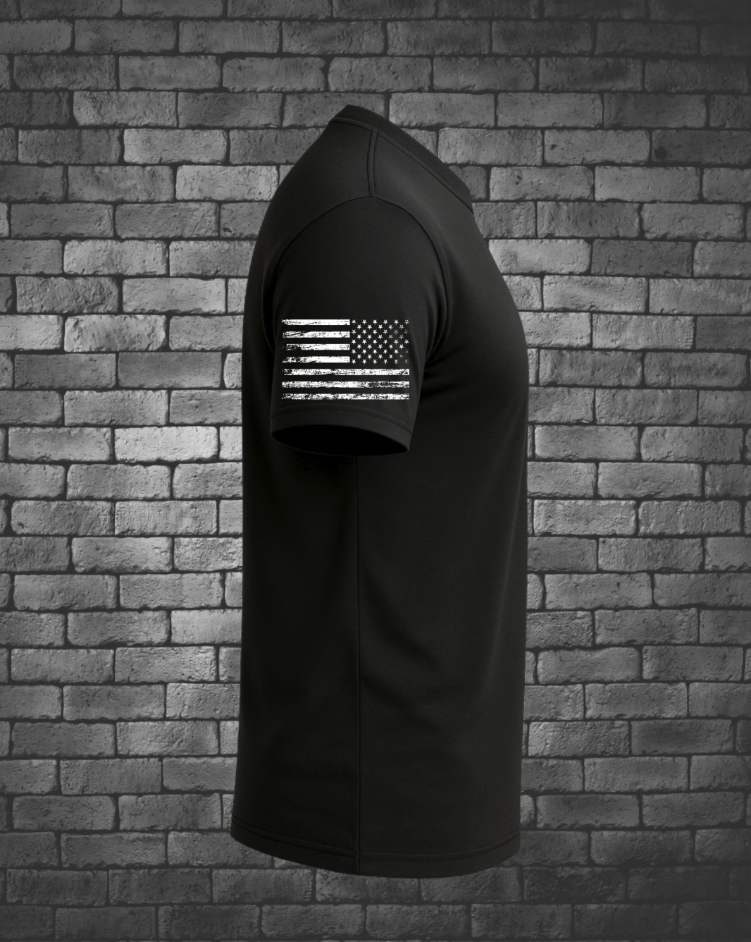 Side view of black JTAC tribute T-shirt featuring a distressed white American flag printed on the sleeve.