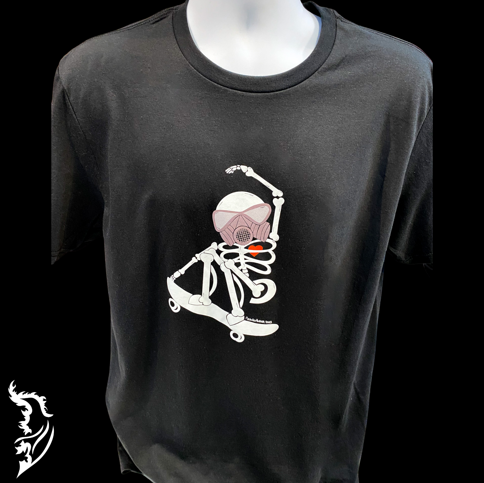 Close-up of a black T-shirt featuring a hand-drawn skeleton riding a skateboard. Story tag states "Skateboarding is not a crime" Author Unknown. Designed for self-expression, the artwork emphasizes individuality and a rebellious spirit. The fabric appears soft and breathable for a perfect casual look.