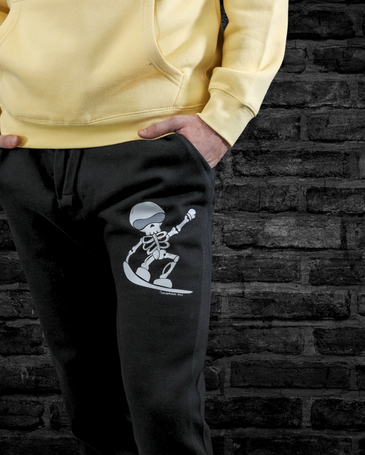 Model wearing ultra-soft fleece Skeleton Snowboarder joggers, featuring a bold hand-drawn design, styled for winter comfort and snowboarding lifestyle
