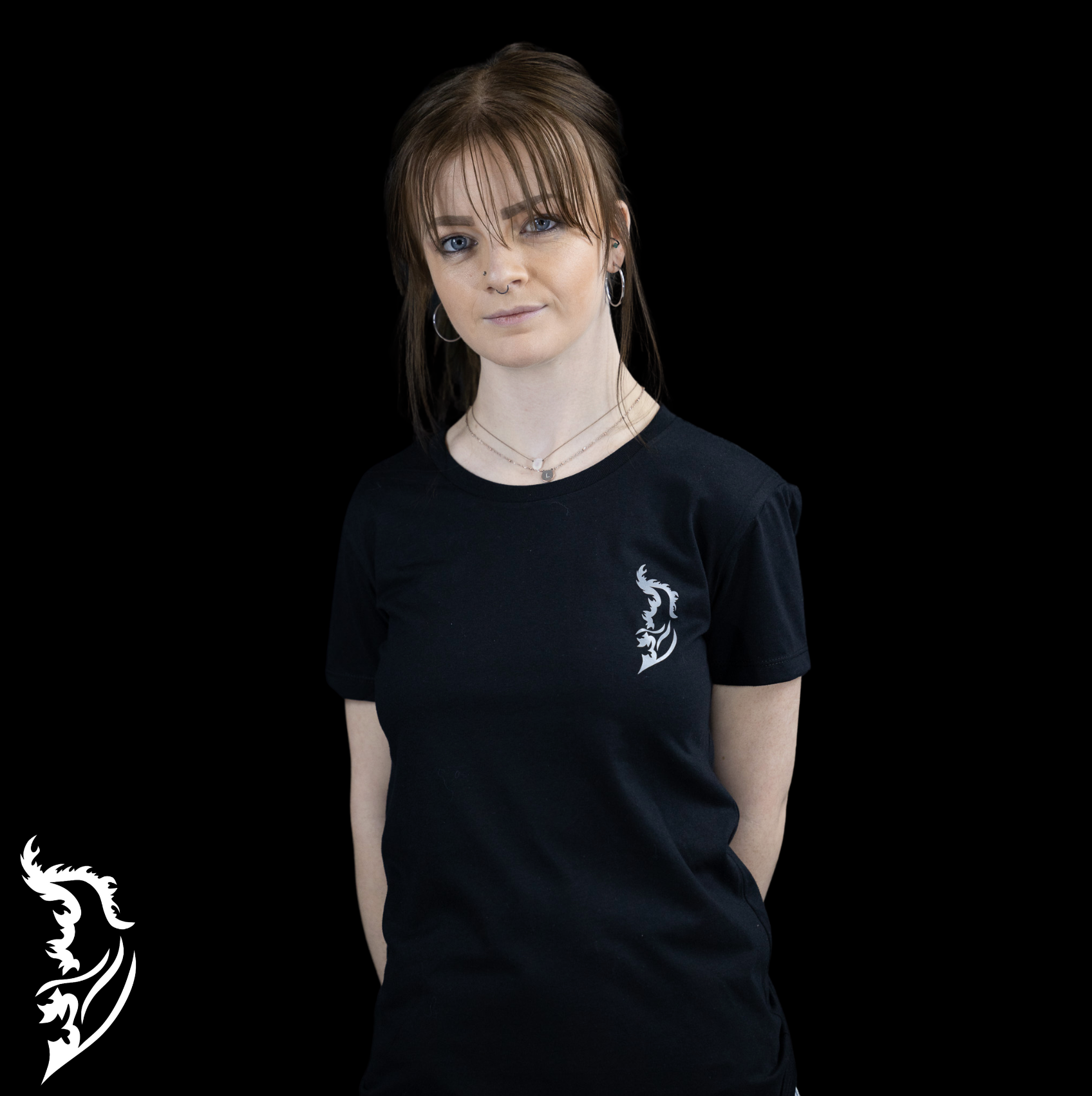 Black ladies' t-shirt with a small angel wing logo printed on the front left chest.