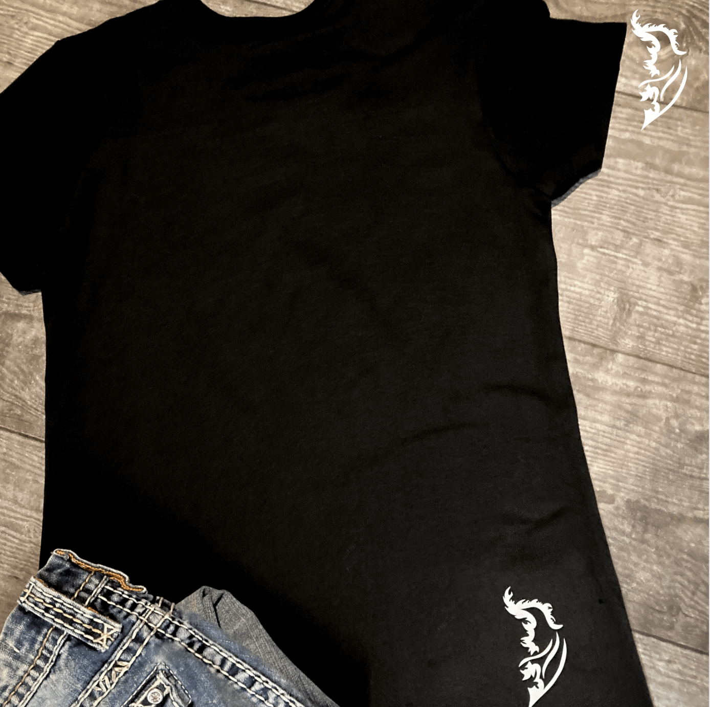 White Angel Wing Logo on lower right side on back of shirt