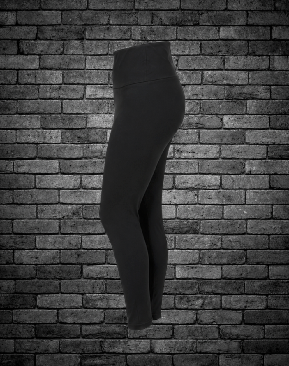 Black leggings against a brick wall background