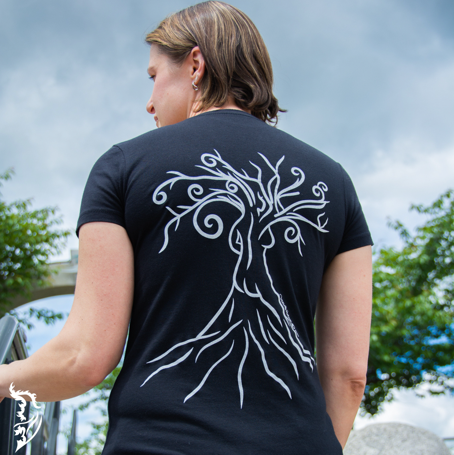 Black T-shirt featuring a hand-drawn line art design of a woman within a tree on the back center.