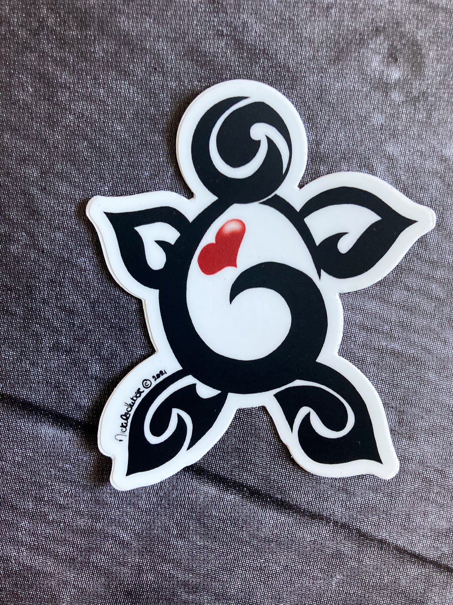 Black tribal-style turtle vinyl sticker with flowing curved lines and a red heart at the center, symbolizing love, longevity, and wisdom.